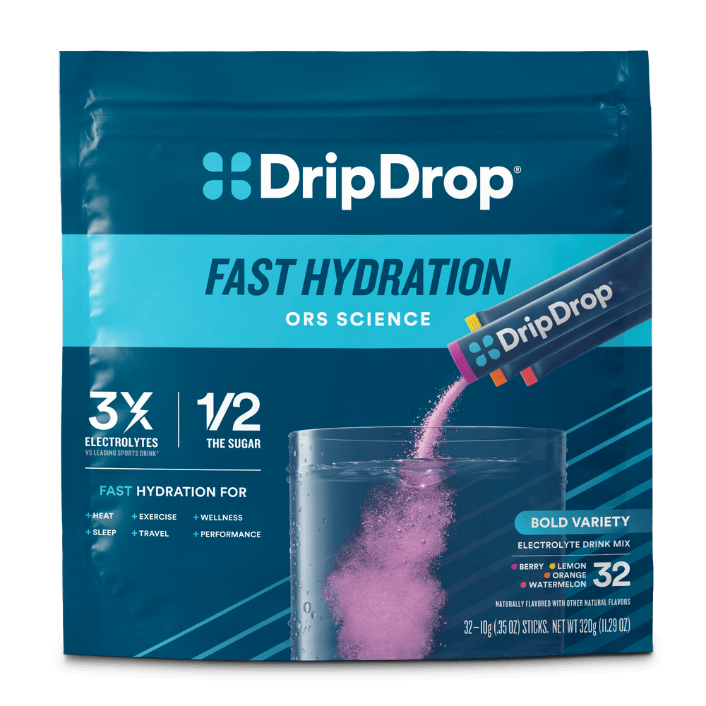 A package of DripDrop Fast Hydration ORS Science drink mix, featuring a dark teal and light blue bag with a sachet pouring pink powder into a clear glass of water. The package highlights electrolyte and shows 32 flavor sticks.
