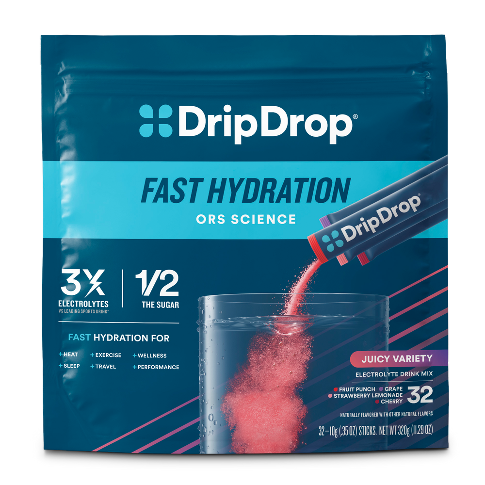 DripDrop Fast Hydration electrolyte drink mix pouch in Juicy Variety flavor, showing a clear glass with pink liquid and powder packets being poured, on a white background.