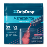 DripDrop Fast Hydration electrolyte drink mix pouch in Juicy Variety flavor, showing a clear glass with pink liquid and powder packets being poured, on a white background.