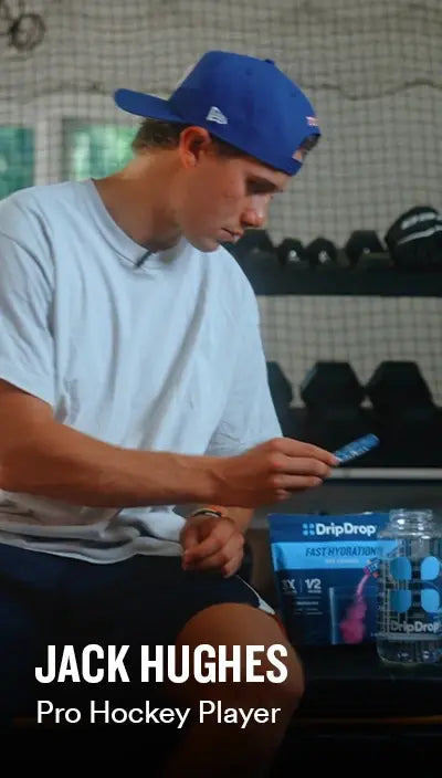 Jack Hughes sitting with a DripDrop product in a gym setting