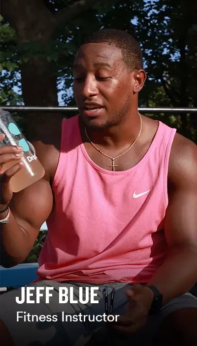 Jeff Blue in pink tank top holding a DripDrop water bottle with DripDrop in it with 'Jeff Blue' text overlay