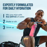 Person holding a pink DripDrop product with hydration instructions on a blue background