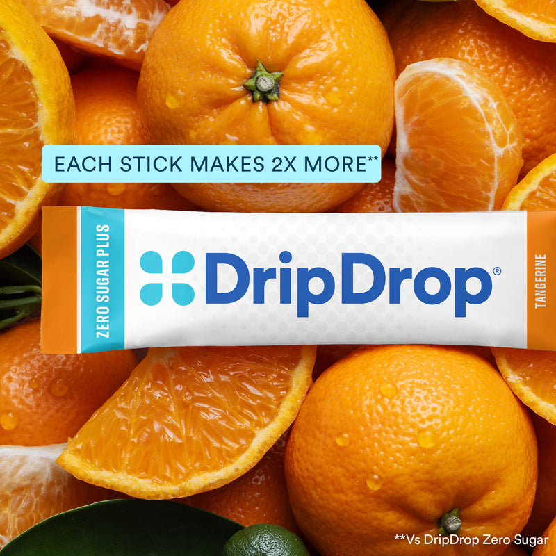 A DripDrop Zero Sugar Plus stick pack for Tangerine flavor, shown horizontally over a close-up background of sliced oranges and orange pulp. The package is white with blue branding and orange side accents.