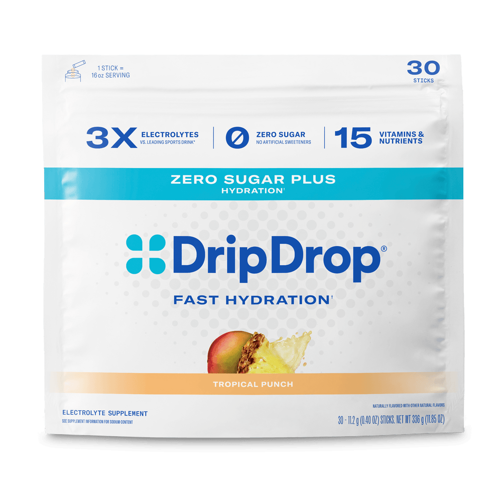 A package of DripDrop Zero Sugar Plus Fast Hydration electrolyte supplement in Tropical Punch flavor. The white pouch features blue and cyan branding, highlighting 3x electrolytes, zero sugar, and 15 vitamins and nutrients per stick.