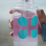 A quick clip of someone pouring DripDrop in their water bottle and drinking it