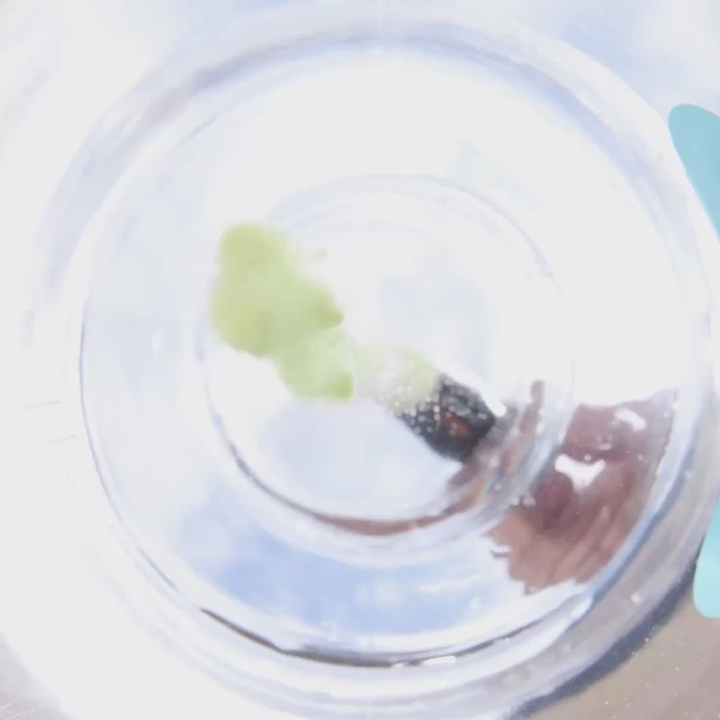 Yellow powder being poured into a water bottle